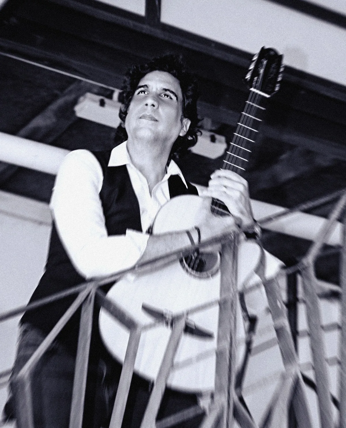 Black and white portrait of Ernesto Castillo holding his guitar